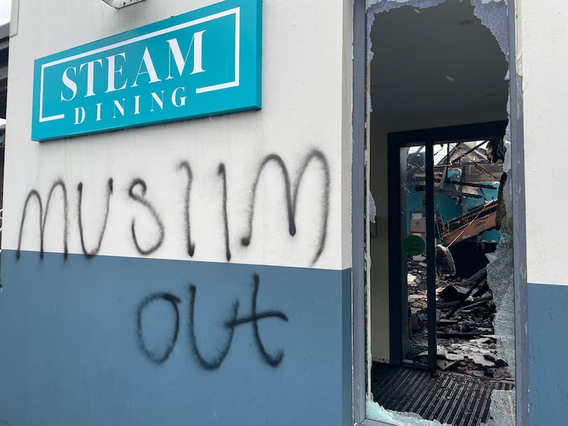 The remains of a bar and restaurant in Newtownabbey following an arson attack which police are treating as hate crime.