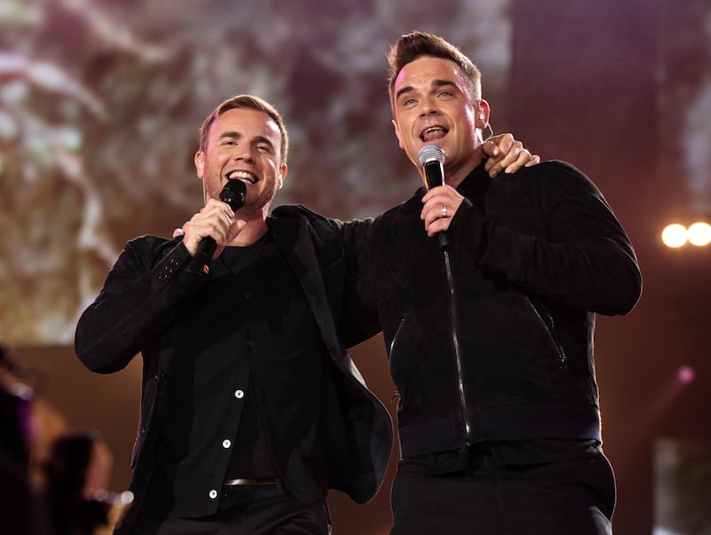 Robbie Williams and Gary Barlow performing at the Help For Heroes Concert