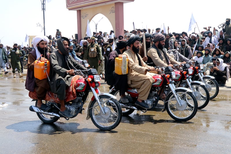 Taliban fighters celebrate the third anniversary of the withdrawal of US-led troops from Afghanistan, in Lashkar Gah (Abdul Khaliq/AP)