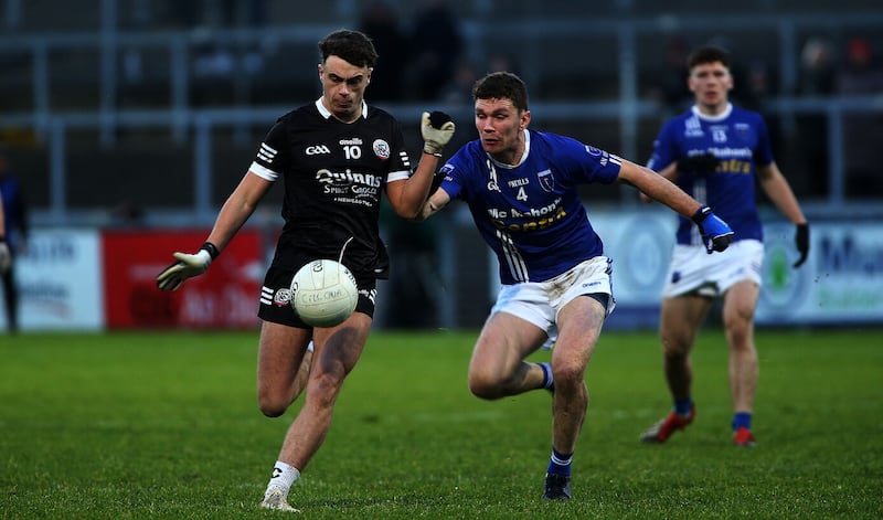 Scotstown captain Damien McArdle closes in on Kilcoo's Shealan Johnston at Pairc Esler. Picture by Seamus Loughran