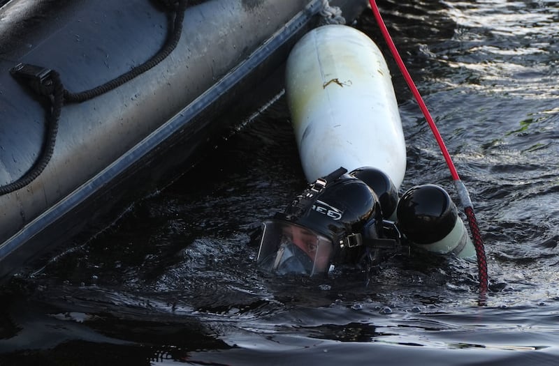 A police diver in the River Dee at Aberdeen harbour during the ongoing search for the sisters