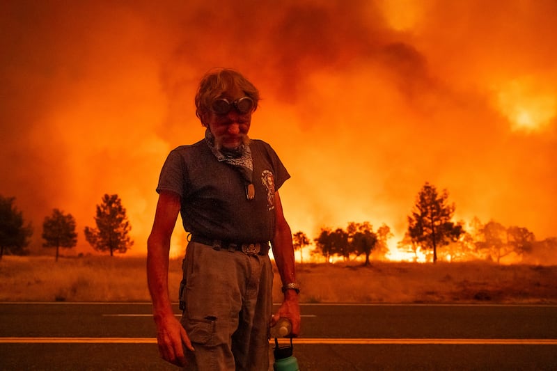 A man pauses while evacuating from an area in Tehama County, California (Noah Berger/AP)