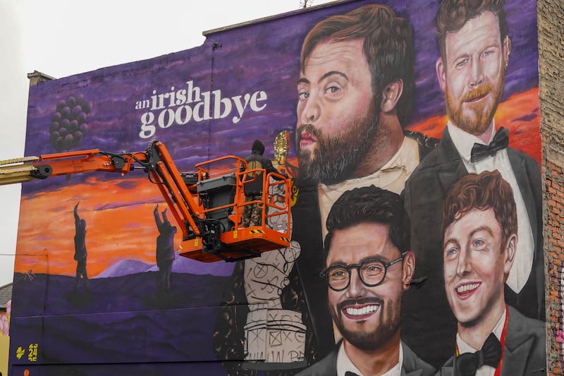 Painting of a mural in Belfast's Winetavern Street dedicated to the film An Irish Goodbye. PICTURE: JORDAN TREANOR