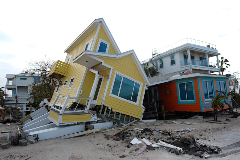 A house lies toppled off its stilts in Bradenton Beach on Anna Maria Island (Rebecca Blackwell/AP)