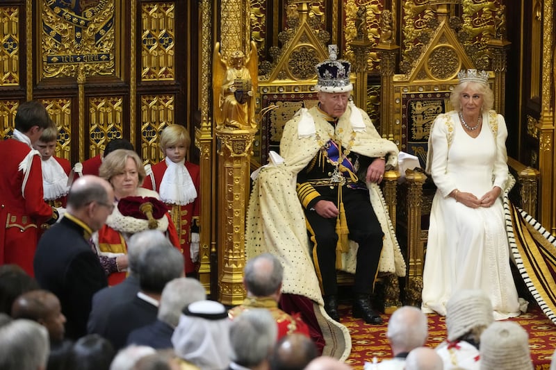 The King with his Robe of State over the arm of his chair after it was adjusted by his pages