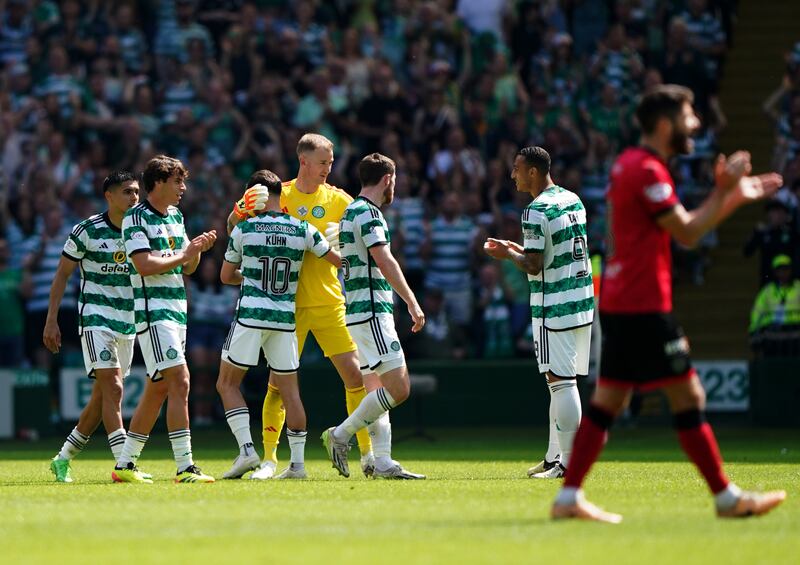 Celtic goalkeeper Joe Hart hugs team-mates as he leaves the pitch