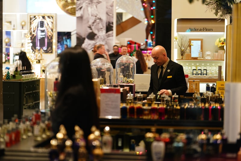 A member of staff at Selfridges in London’s Oxford Street prepares for the department store’s Boxing Day sale