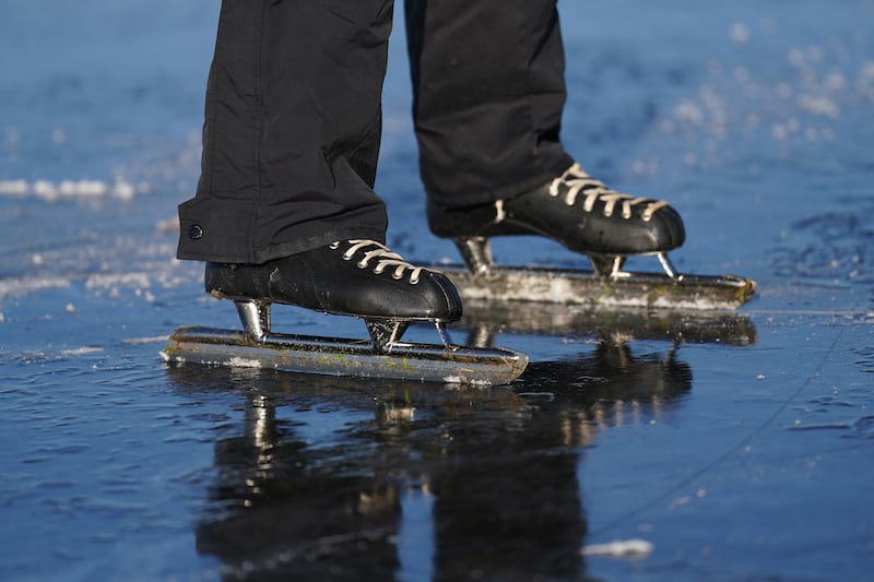 Paul Jansen skates on the frozen flooded field in Upware