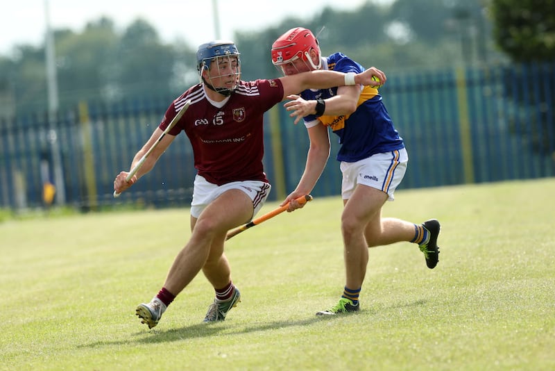 Rossa’s  Conor Boyle and Cushendall’s Joseph McLaughlin during Sunday’s game at Shaw’s Road in Belfast.
PICTURE COLM LENAGHAN