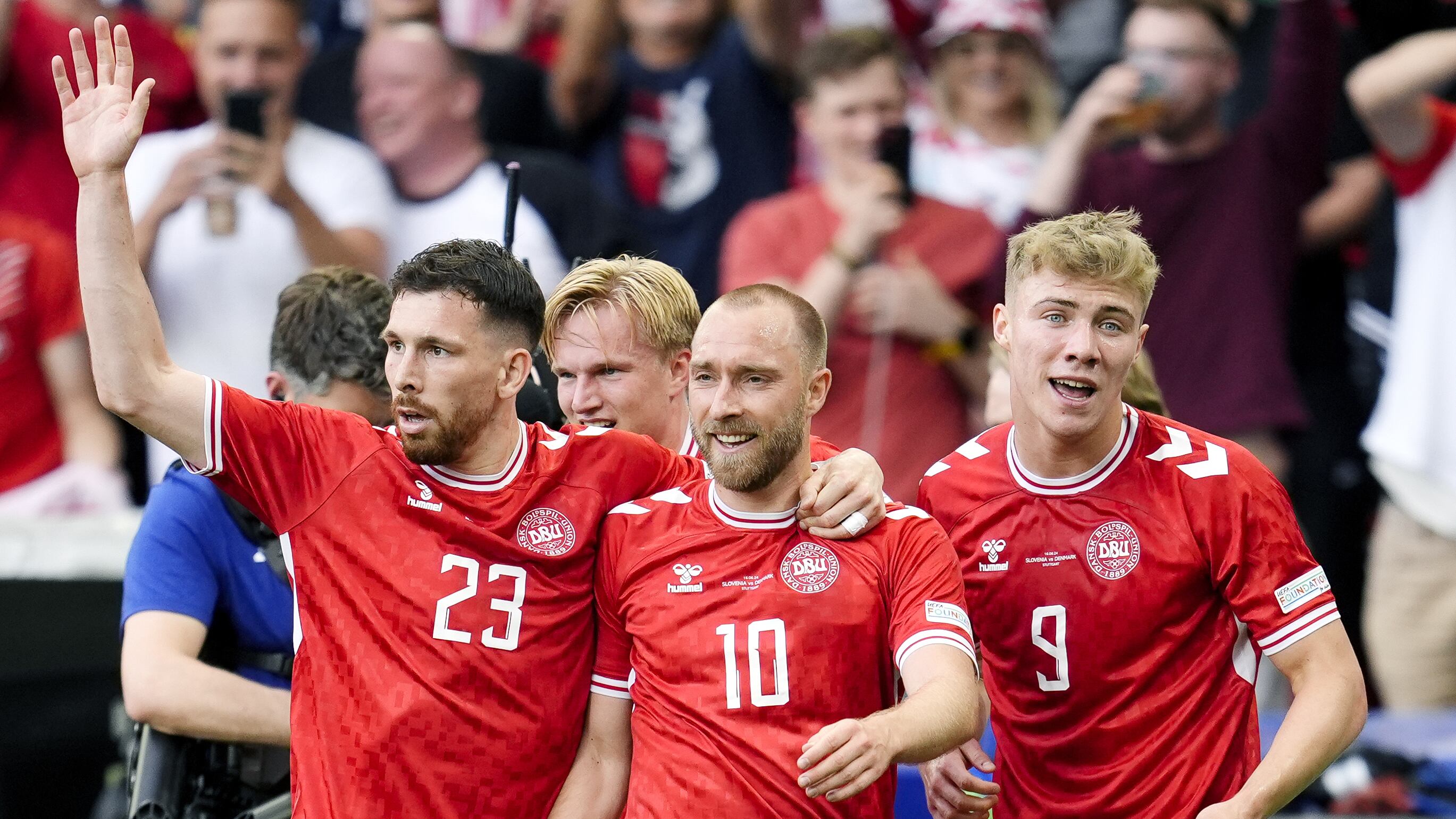 Christian Eriksen, centre, celebrates with team-mates after scoring Denmark’s opener