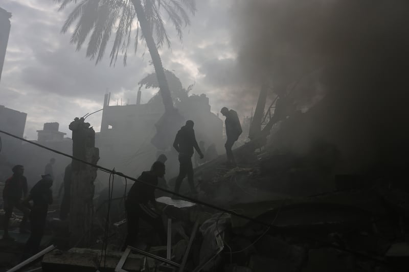 Palestinians look for the survivors of an Israeli strike in Rafah, Gaza Strip (Hatem Ali/AP)