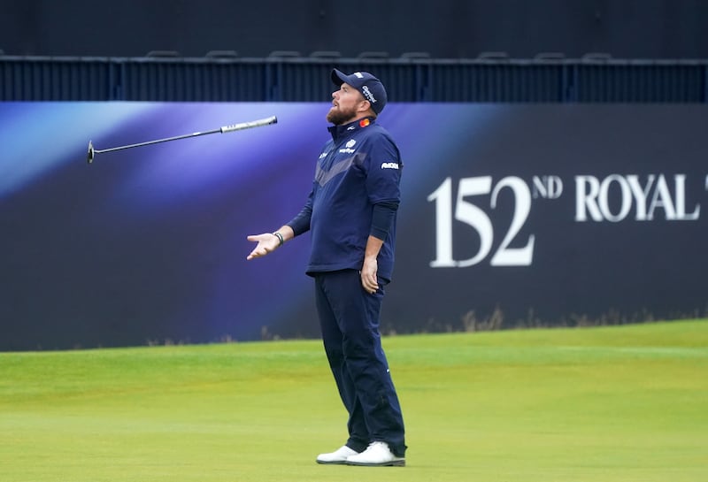 Ireland’s Shane Lowry throws his putter in the air on the 18th during a third round of 77 in the Open