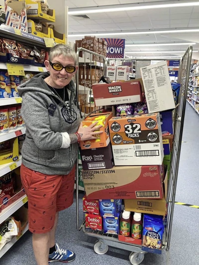 Cathy Stevenson, a Kinship Care volunteer, loads up emergency food for hundreds of vulnerable elderly and young carers 