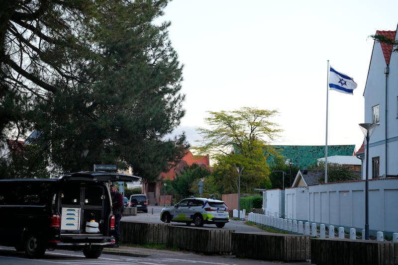 A police vehicle is seen near the Israeli embassy in Copenhagen, as police investigate two explosions near the site (Emil Helms/Ritzau Scanpix via AP)