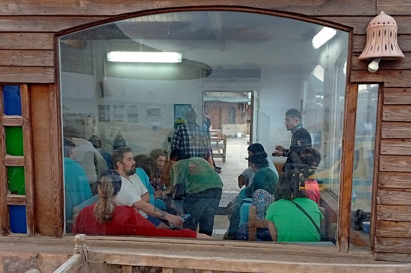 Survivors rest at a coffee shop in Marsa Alam (AP)