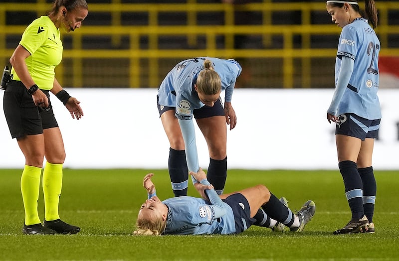 Alex Greenwood lies stricken on the pitch