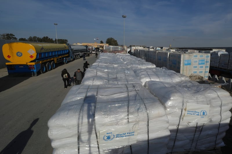 Trucks carrying humanitarian aid line up to cross the Rafah border crossing between Egypt and the Gaza Strip (Amr Nabil/AP)