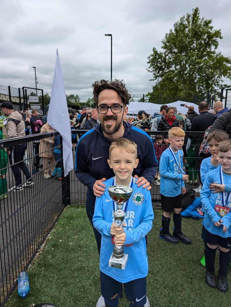 Dylan Hume parades the winning trophy for St Mary's 2015s with his dad and coach Ross Hume. Dylan was diagnosed with Aplastic anemia last July and is searching for a stem cell transplant match