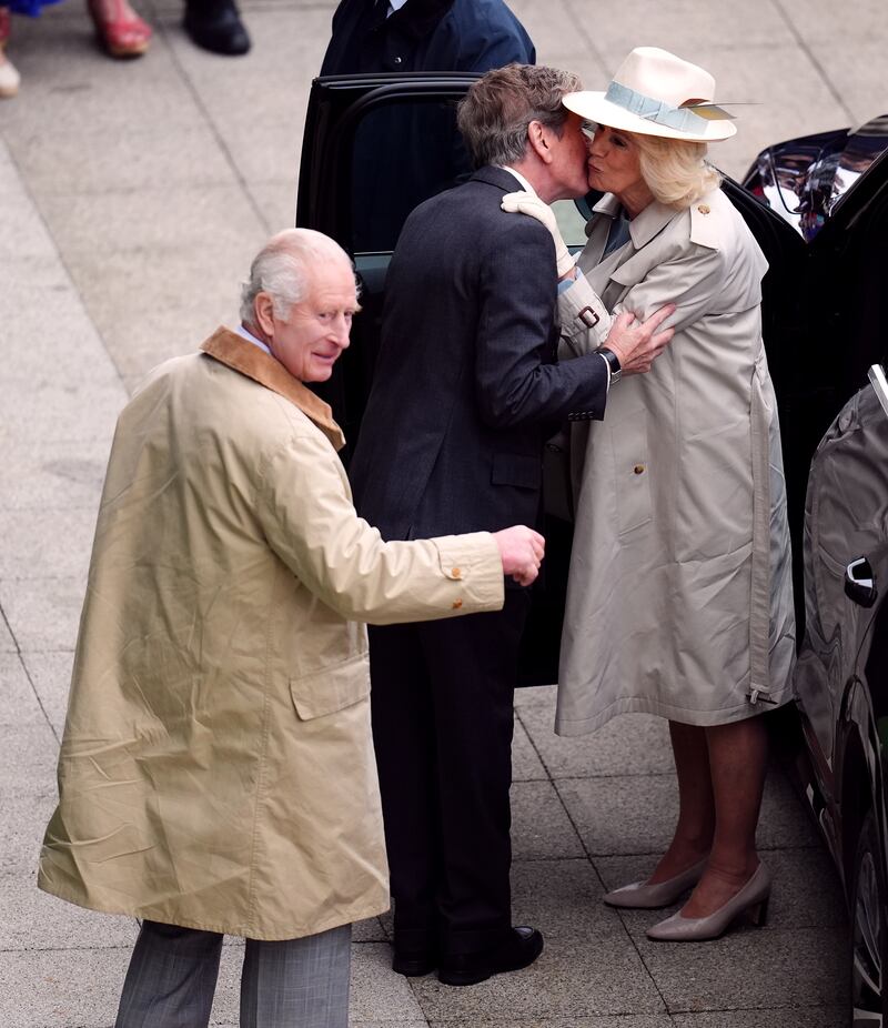 Camilla is greeted with a kiss by John Warren, the King and Queen’s racing manager