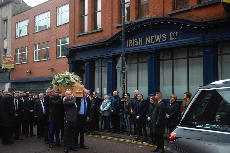 The funeral of Hugh Russell stops at The Irish News offices on Donegal street where his work colleagues friends and family join in a round of applause. Picture Mark Marlow