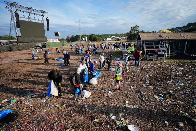 Litter and rubbish being picked up at the end of the Glastonbury Festival at Worthy Farm