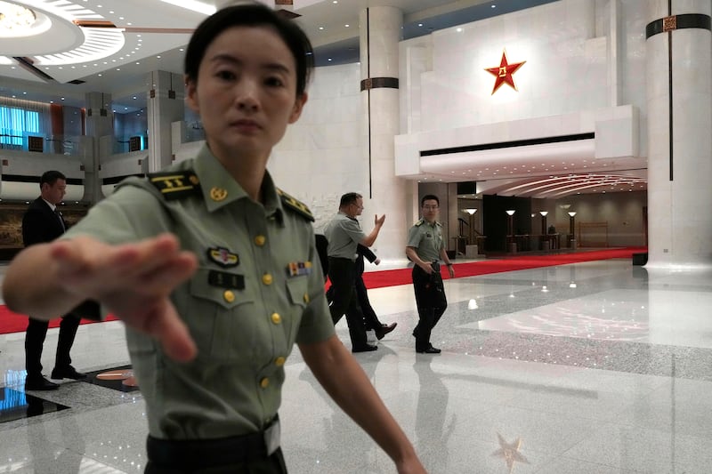 A security guard wards away the media from Jake Sullivan in Beijing (AP Photo/Ng Han Guan, Pool)