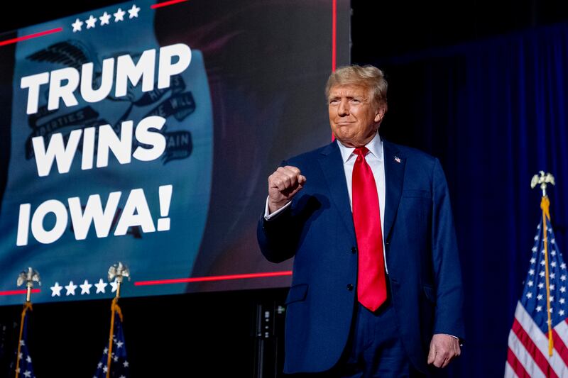 Former president Donald Trump takes to the stage at a caucus night party in Des Moines, Iowa (Andrew Harnik/AP)