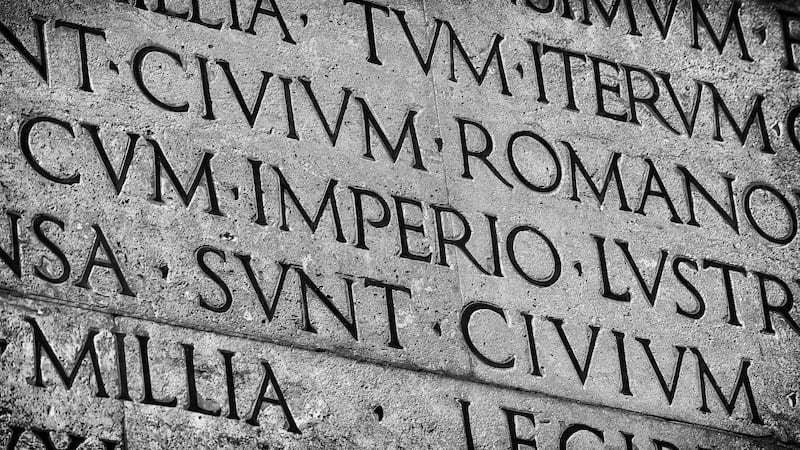 Latin ancient language and classical education. Inscription from Emperor Augustus famous Res Gestae (1st century AD), with the word Imperio in the center