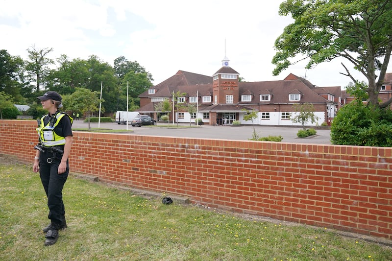 Police officers outside the Potters International Hotel in Aldershot