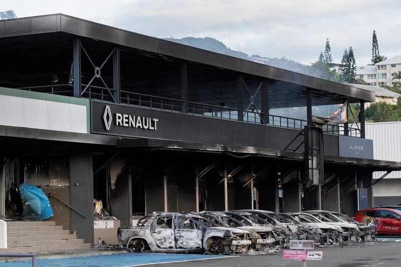 A burnt car store is pictured in Noumea, New Caledonia (Cedric Jacquot/AP)