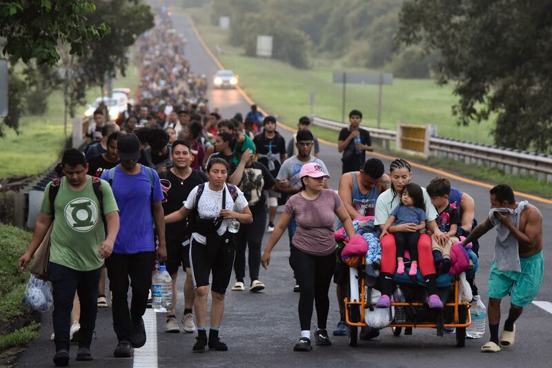 FILE – Migrants walk along the Huixtla highway toward the United States. (Edgar H. Clemente, File/AP)