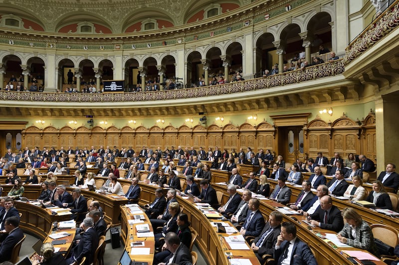 Members of Parliament sit in the National Council hall during Federal Council elections, in Bern, Switzerland, in December 2019 (Anthony Anex/Keystone/AP)