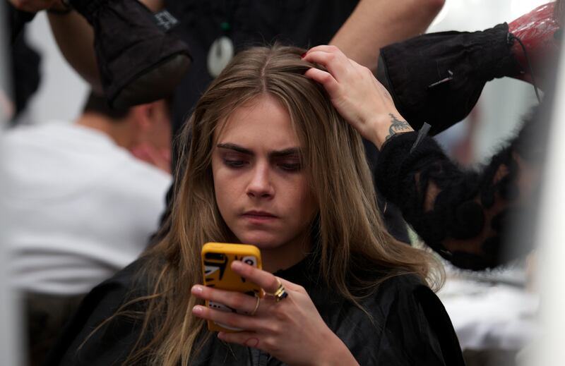 Cara Delevingne gets ready back stage for the Burberry collection during the 2014 Autumn / Winter London Fashion Week