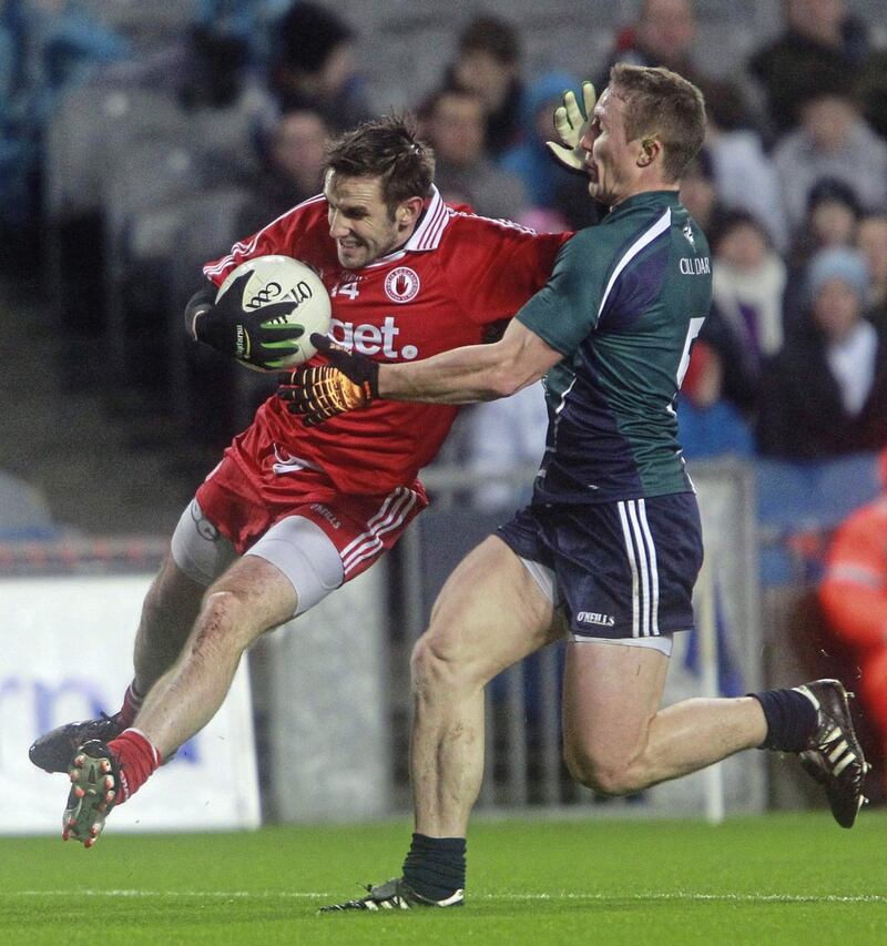 Former Tyrone forward Mark Donnelly battling his way past Kildare&#39;s Brian Flanagan. Pic: Hugh Russell 