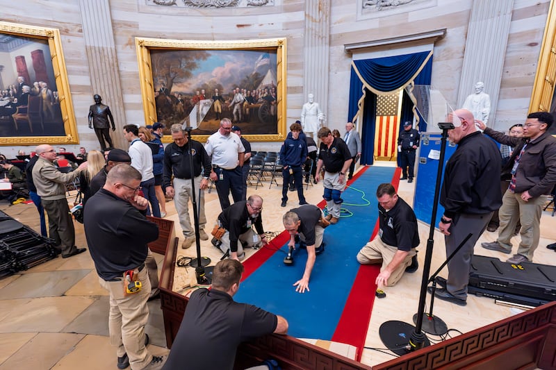 Organisers work to move the Inauguration Day swearing-in ceremony into the Capitol Rotunda (J Scott Applewhite/AP)