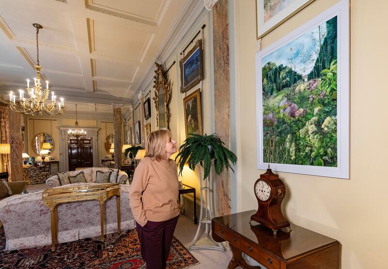 Castle Steward Kim Diver admires a brand new contemporary painting, Late Summer on Yew Tree Walk (2024) by local artist Emma Spence.