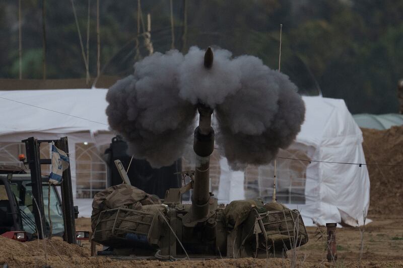 An Israeli mobile artillery unit fires a shell from southern Israel towards the Gaza Strip (AP)