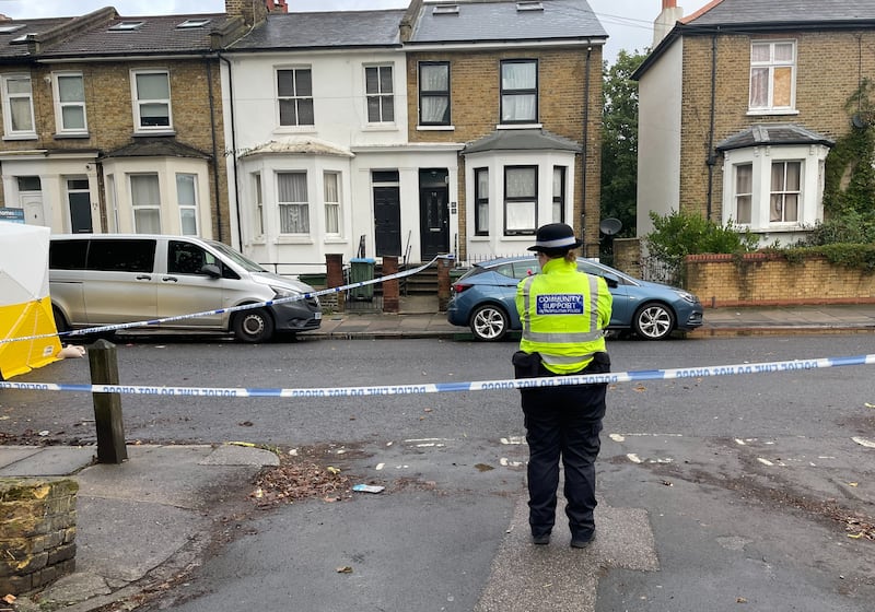 A Metropolitan police officer stands near a police cordon and forensic tent on Paget Terrace, near the scene in Eglinton Road