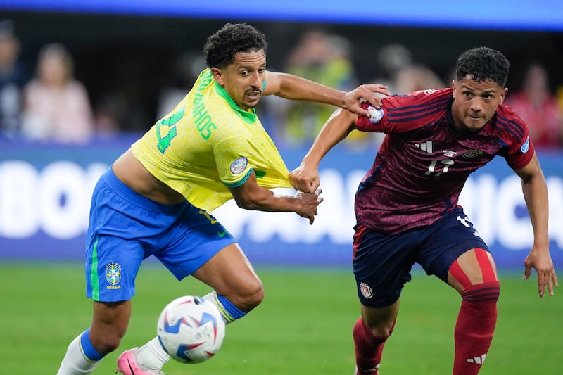 Costa Rica’s Warren Madrigal, right, is defended by Brazil’s Marquinhos (Mark J Terrill/AP)