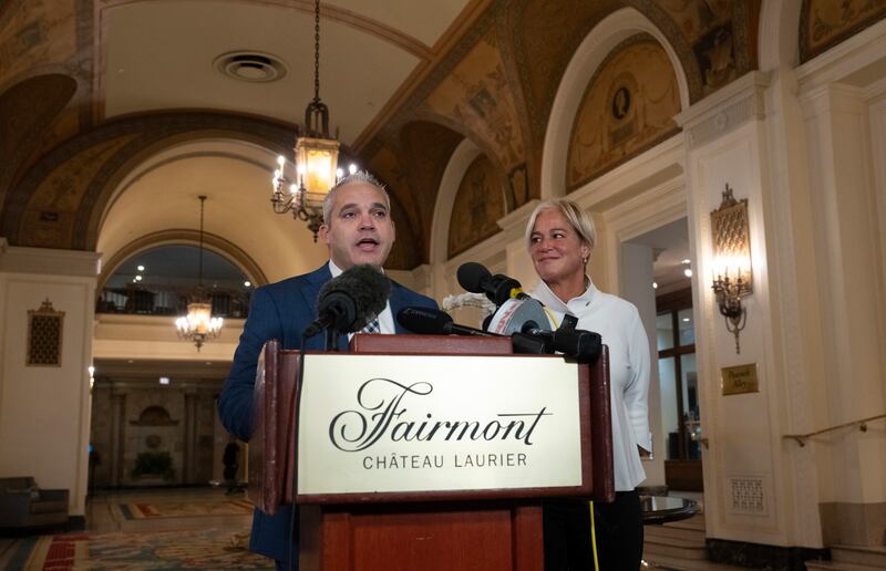 Fairmont Chateau Laurier general manager Genevieve Dumas looks on as Ottawa police detective Akiva Gellar speaks about the portrait (Adrian Wyld/The Canadian Press via AP)