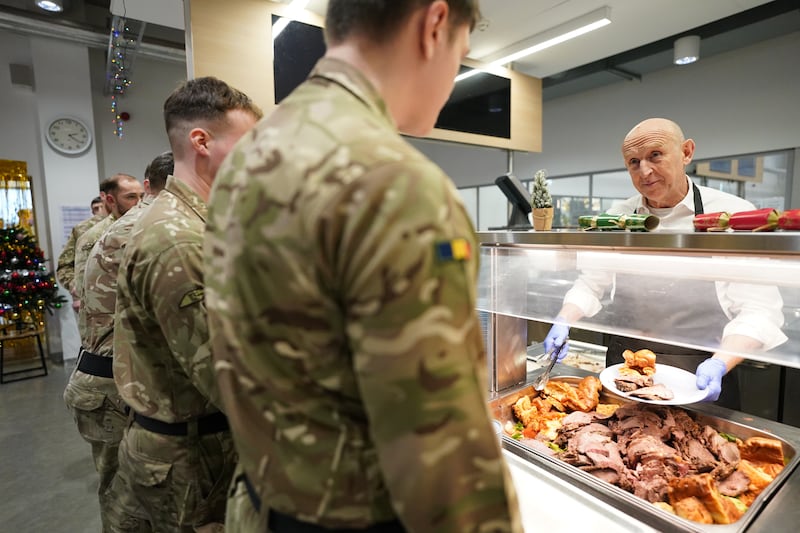 Defence Secretary John Healey serving Christmas lunch to British personnel during his visit to the Tapa military base in Estonia