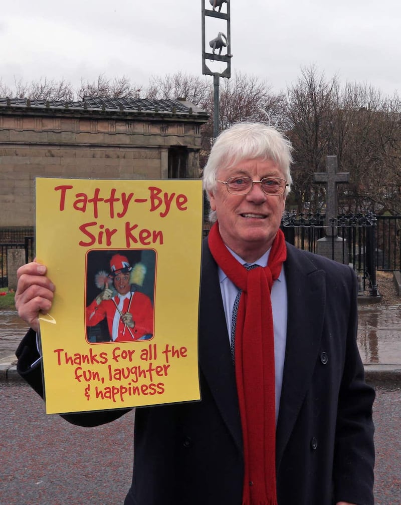 A fan of Sir Ken Dodd holds up a tribute (Peter Byrne/PA)