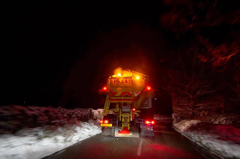 A gritter salts a road in the centre of Buxton, Derbyshire