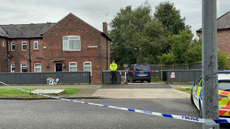 Police stand guard outside a house on South Radford Street, Salford, where a woman and her daughter were found dead on Monday, September 23, 2024.