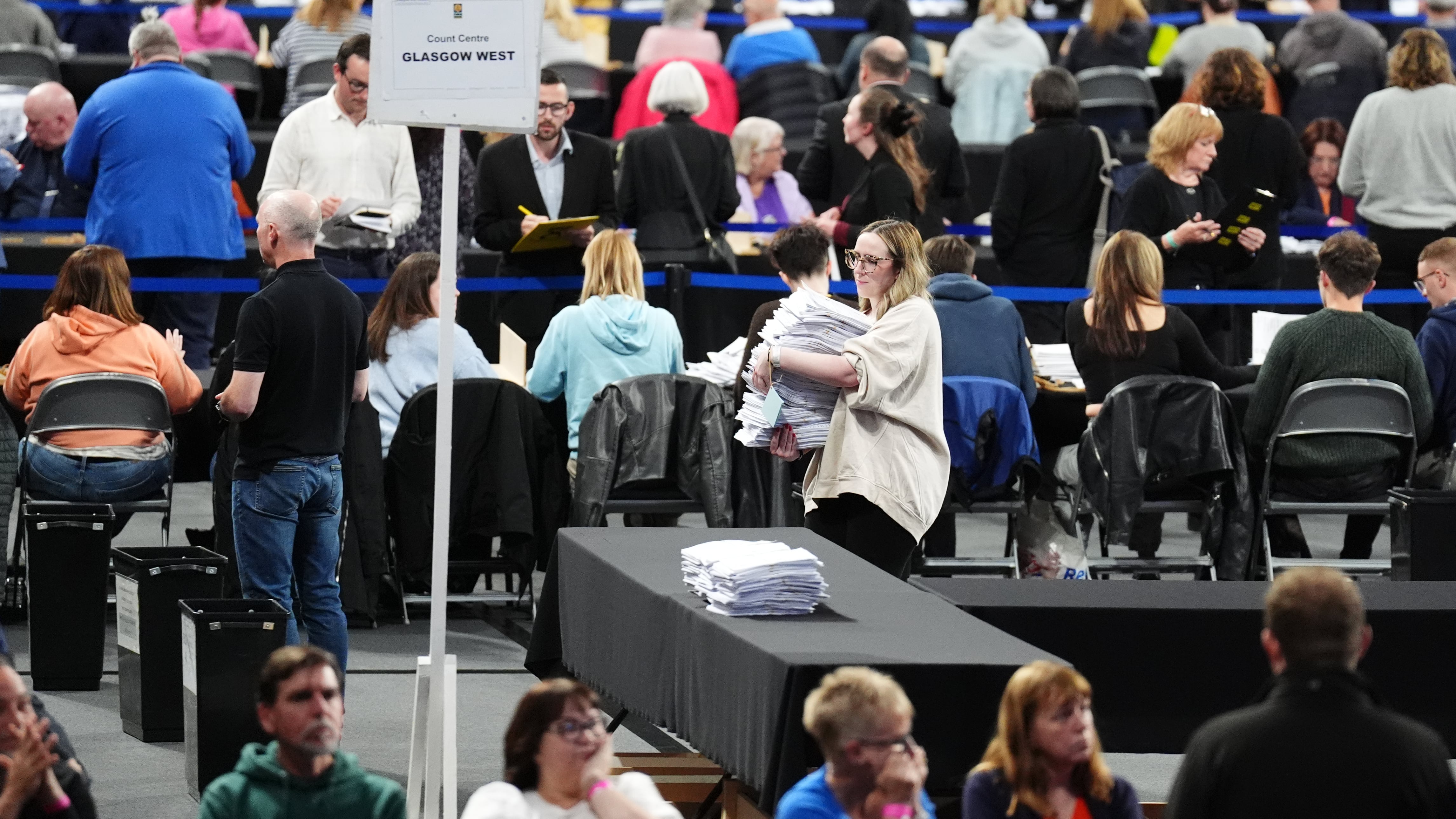 Ballot papers are moved at Emirates Arena in Glasgow, during the count for Glasgow Central and Glasgow South constituencies in the 2024 General Election