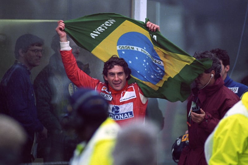 Ayrton Senna flying the Brazilian flag after victory in the European Grand Prix at Donnington Park