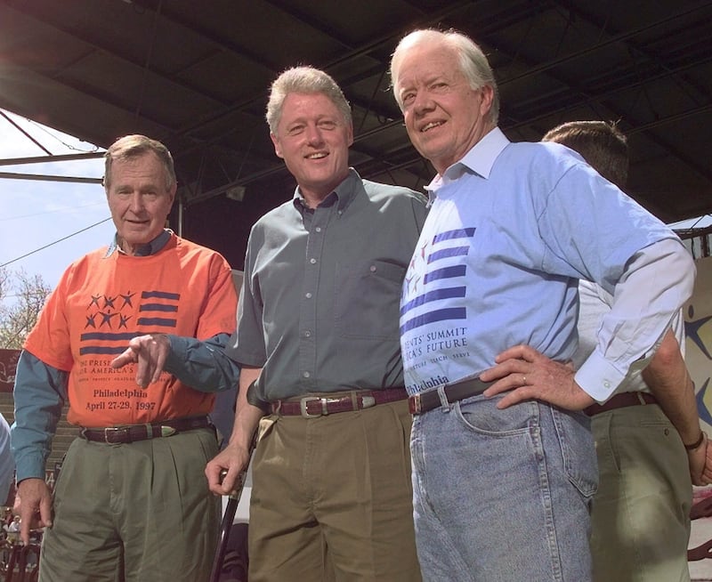 Former presidents George Bush, left, and Jimmy Carter, right, with Bill Clinton