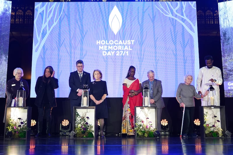 Survivors light candles on stage