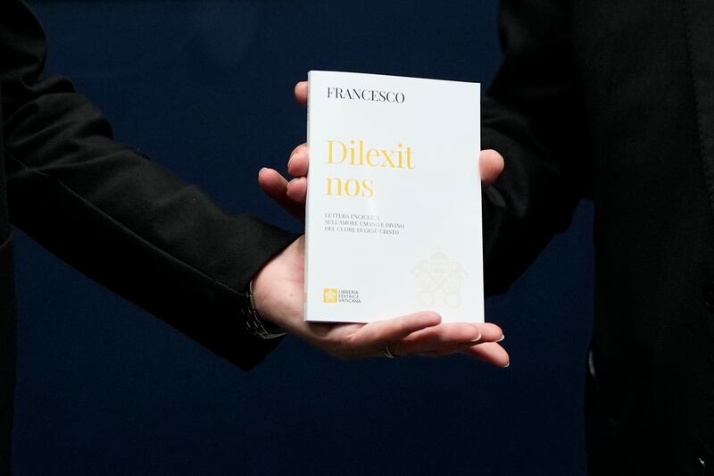 A copy of Pope Francis’ encyclical titled ‘Dilexit Nos’, Latin for ‘He Loves Us’, is shown after a press conference for its presentation at the Vatican (Alessandra Tarantino/AP)