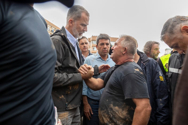 Spain’s King Felipe VI speaks with people in the crowd of angry flood survivors in Paiporta, near Valencia (David Melero/AP)